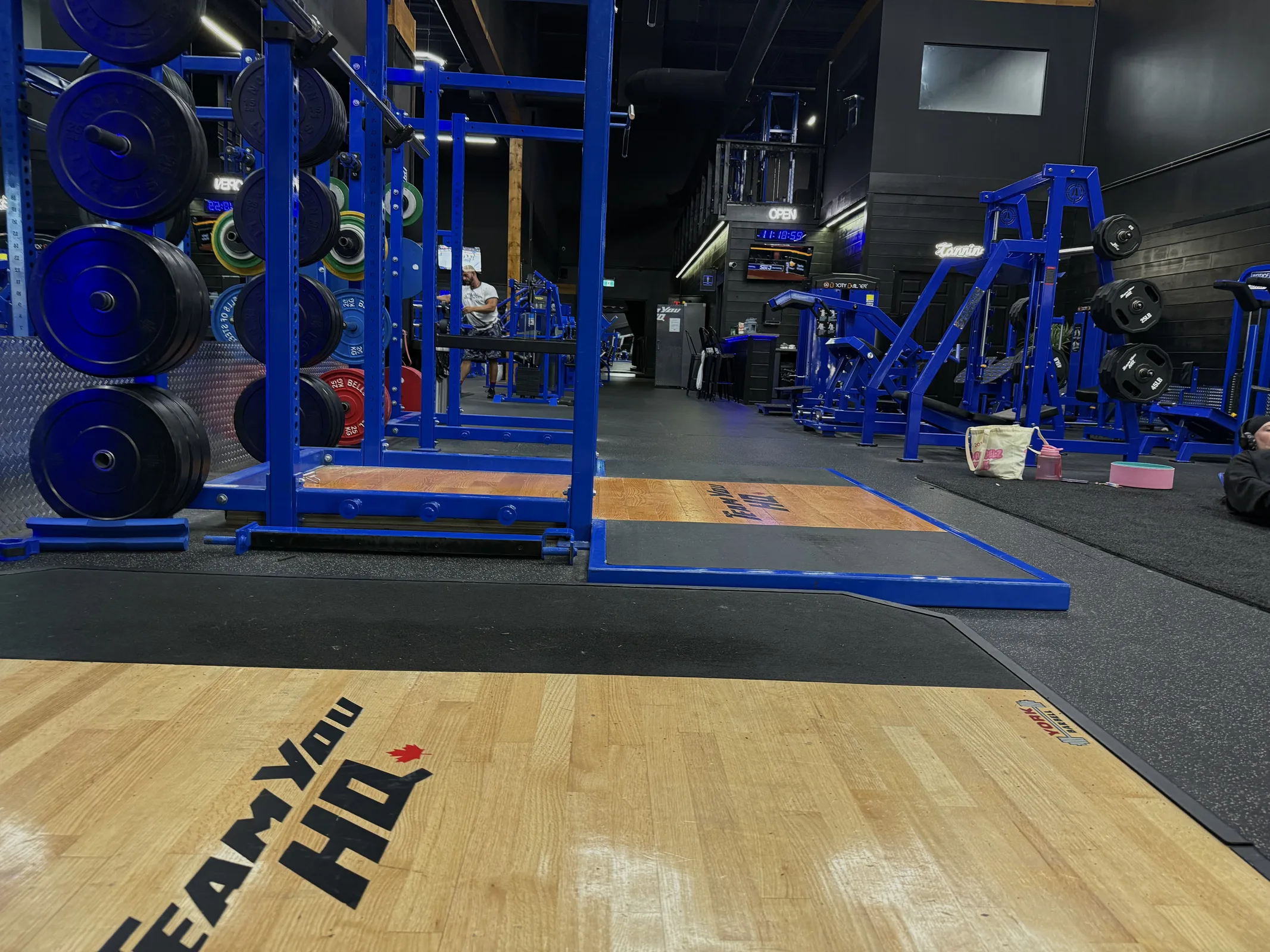 TeamYou HQ gym floor beneath signature hexagon LED ceiling